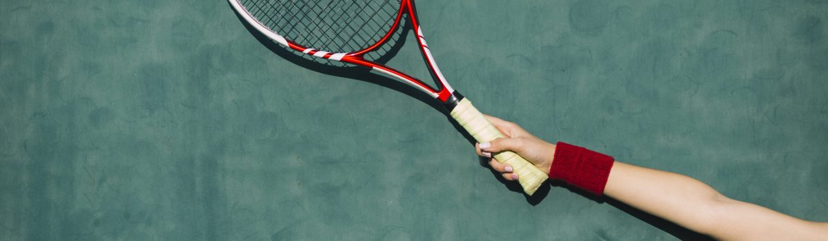 woman-holding-tennis-racket-hand